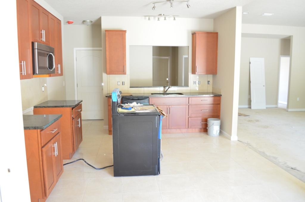 4604 Hermosa Road Crestview, FL 32539 - Photo 11 of 12 a kitchen with kitchen island a sink a stove and a refrigerator
