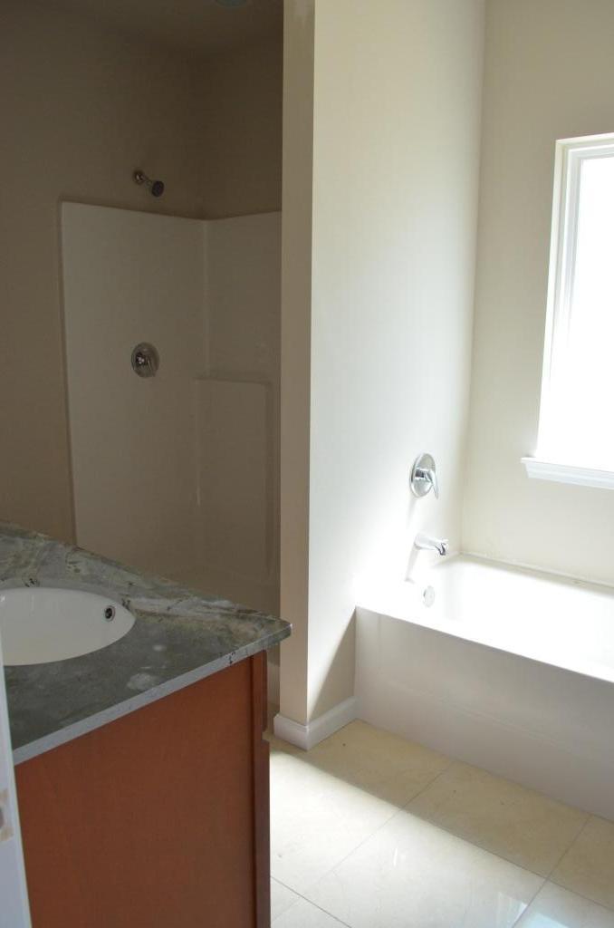 4604 Hermosa Road Crestview, FL 32539 - Photo 9 of 12 a bathroom with a tub sink and mirror