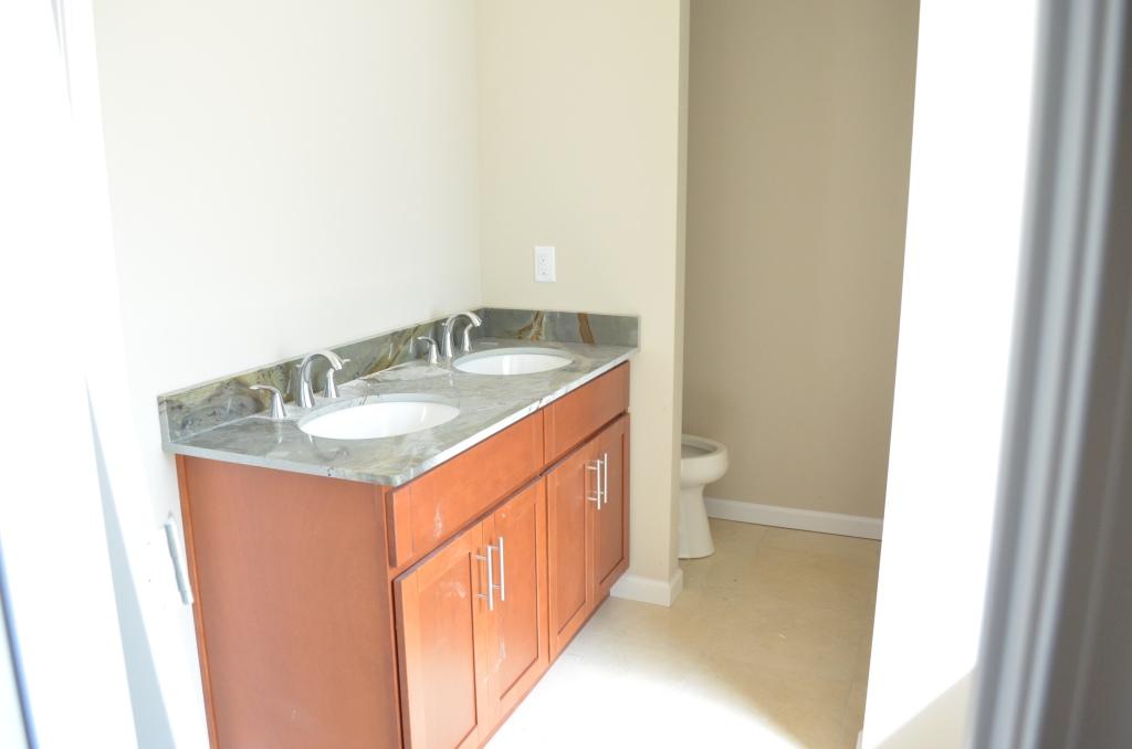 4604 Hermosa Road Crestview, FL 32539 - Photo 10 of 12 a bathroom with a granite countertop sink and a toilet