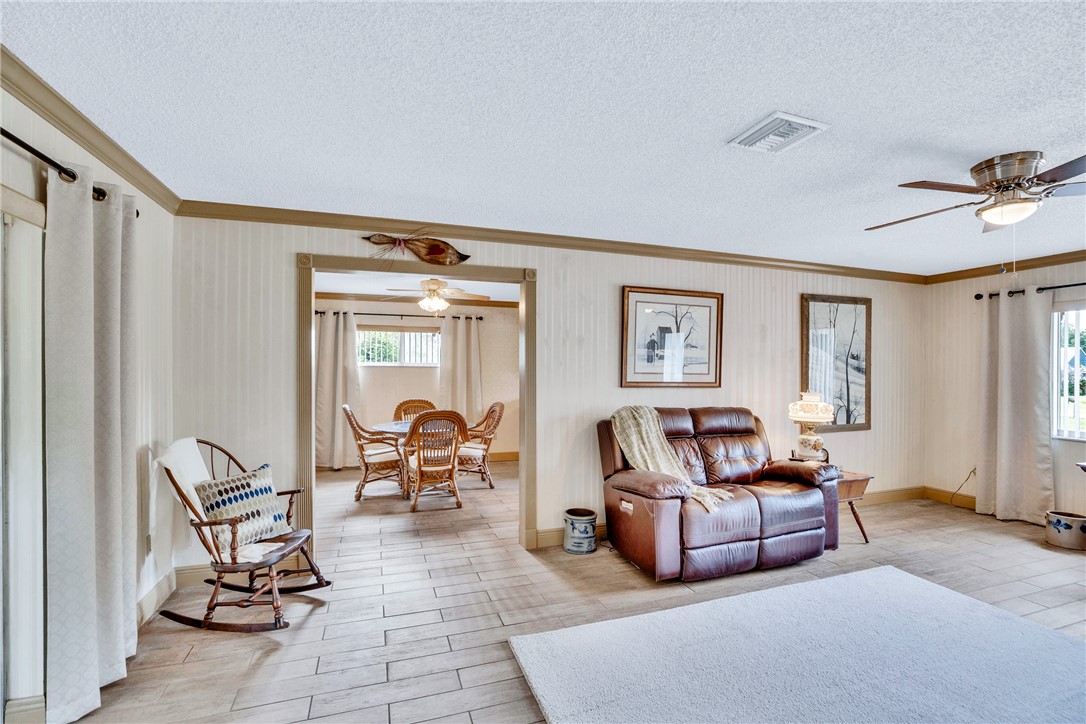 7666 134th Street Sebastian, FL 32958 - Photo 21 of 35 a living room with furniture and a window