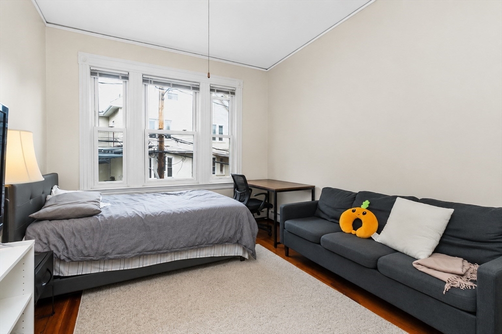 8 Colliston Road Boston, MA 02135 - Photo 5 of 40 a bedroom with a bed and window