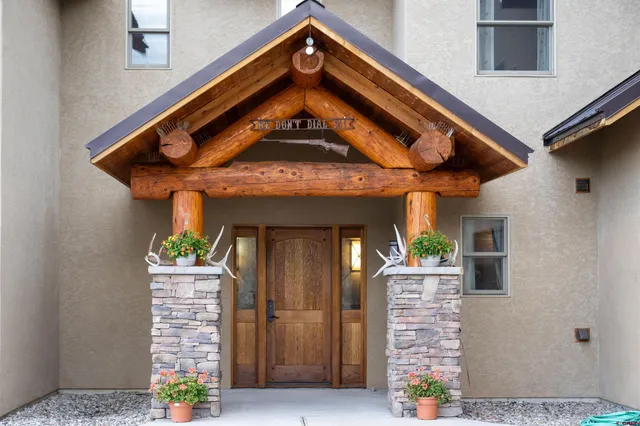 front view of a house with a potted plant and stairs