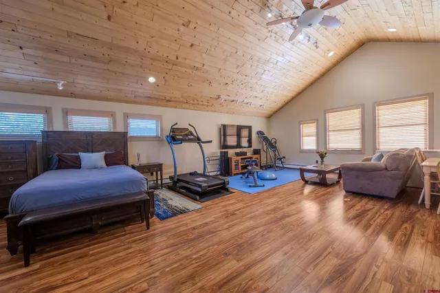 a bedroom with furniture and a wooden floor