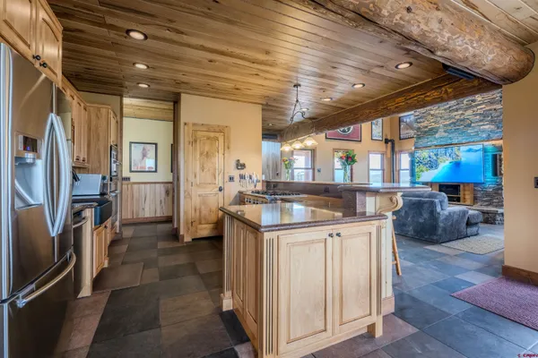 a spacious bathroom with a granite countertop sink a mirror and a shower