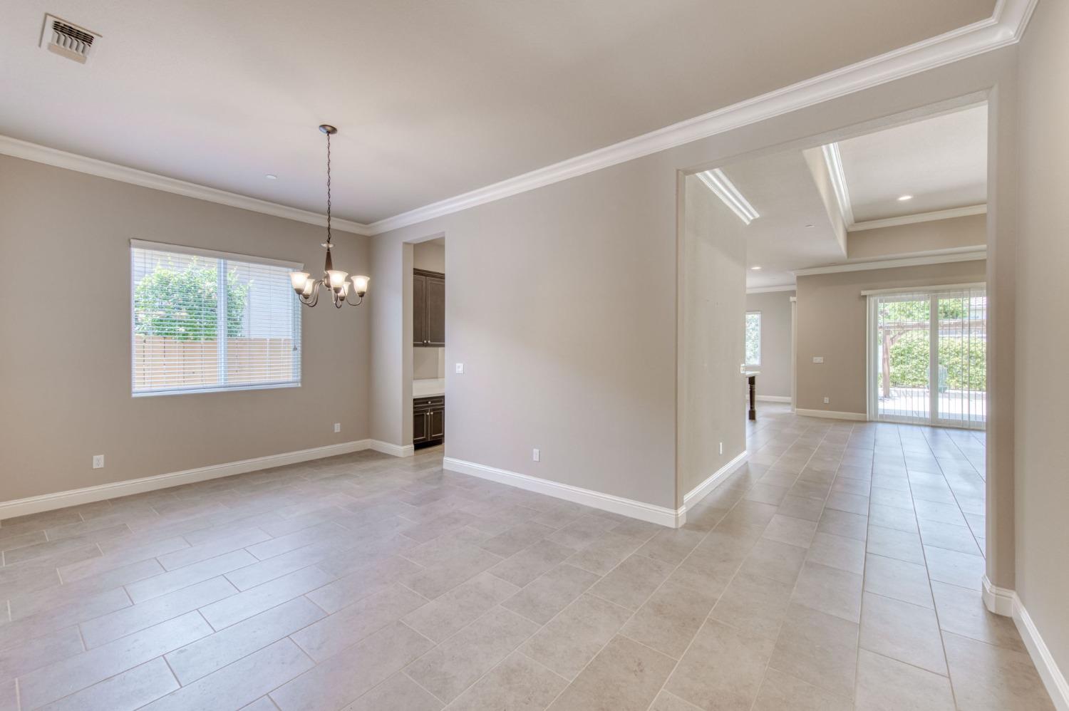 3301 Salem Avenue Clovis, CA 93619 - Photo 11 of 41 a view of an empty room with window and chandelier fan