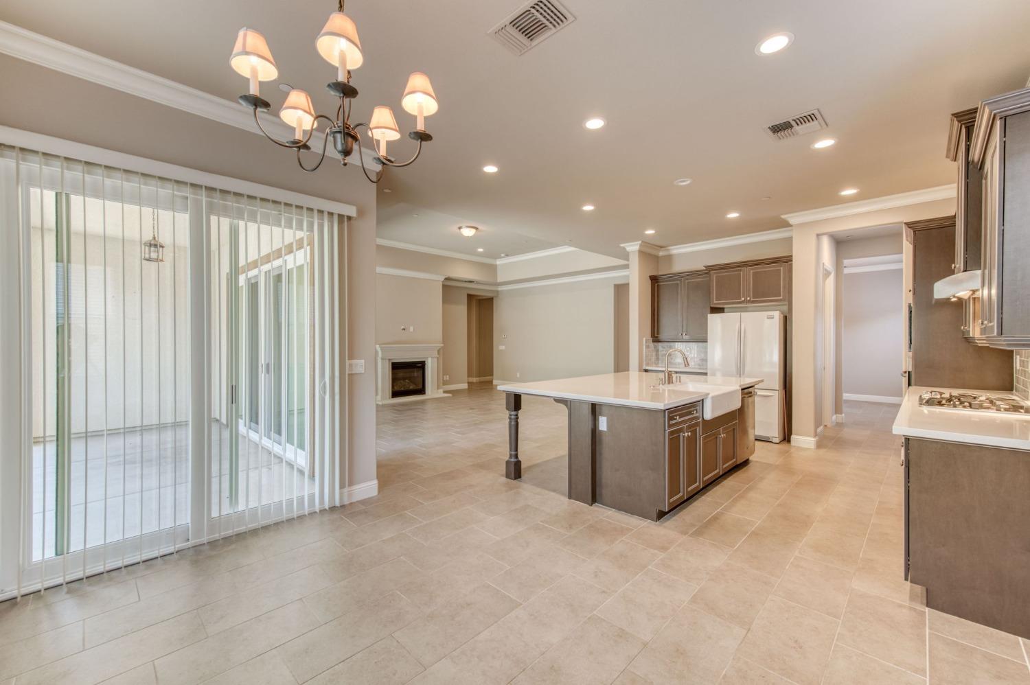 3301 Salem Avenue Clovis, CA 93619 - Photo 18 of 41 a large white kitchen with a large counter top appliances and cabinets
