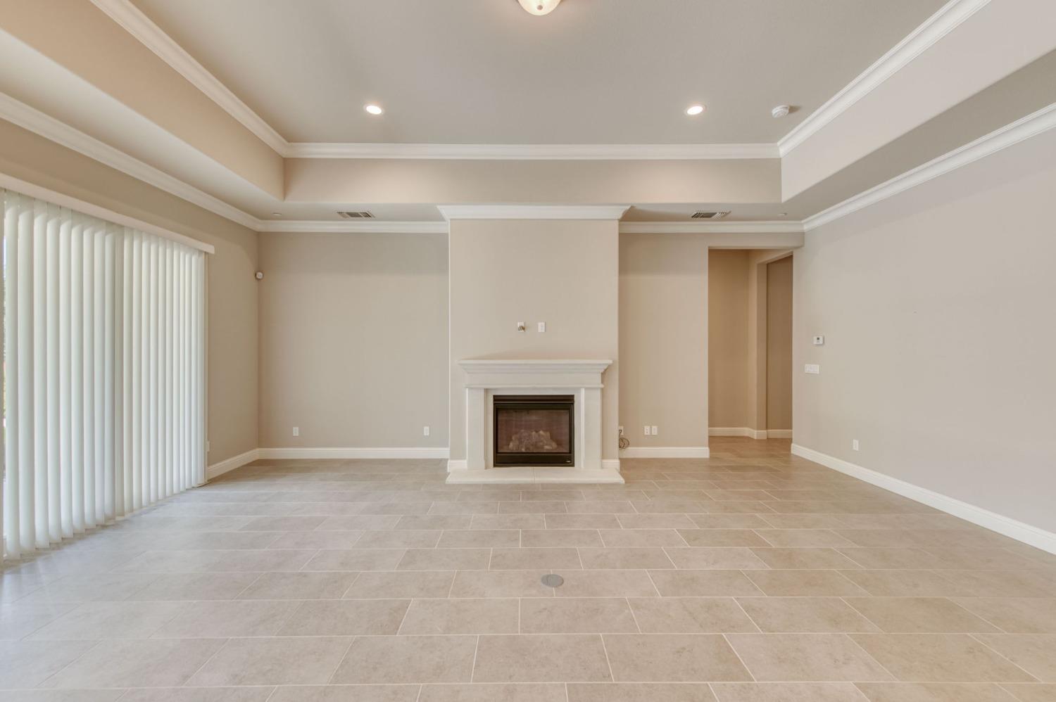 3301 Salem Avenue Clovis, CA 93619 - Photo 20 of 41 an empty room with a fireplace and a window