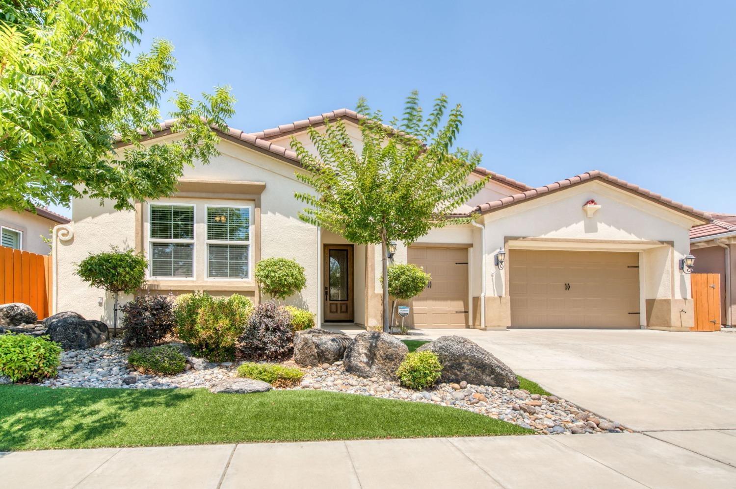 3301 Salem Avenue Clovis, CA 93619 - Photo 3 of 41 a front view of a house with a yard and potted plants