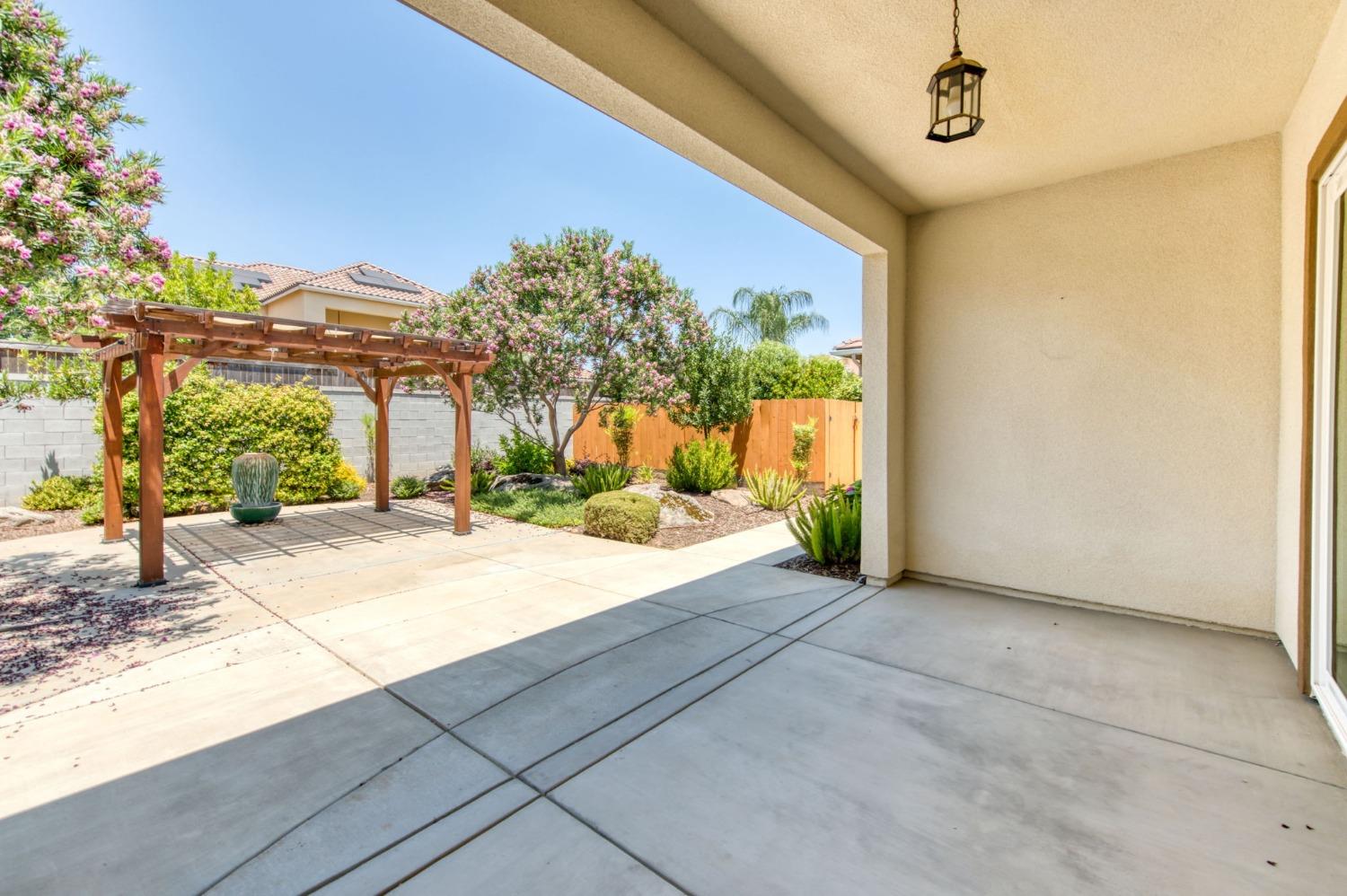 3301 Salem Avenue Clovis, CA 93619 - Photo 33 of 41 a bedroom with a bed and a chandelier