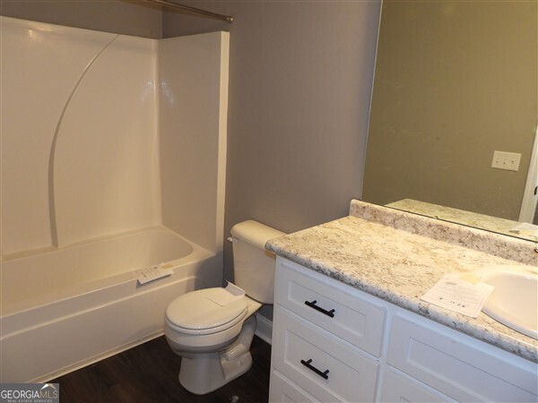 5915 Rye Patch Road Ludowici, GA 31316 - Photo 21 of 25 a bathroom with a granite countertop toilet and a bathtub