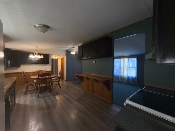 a dining room with furniture and wooden floor