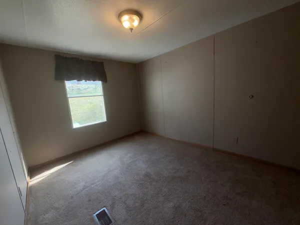 a kitchen with granite countertop a refrigerator and a sink