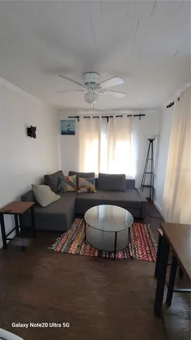 a living room with furniture a rug and a chandelier