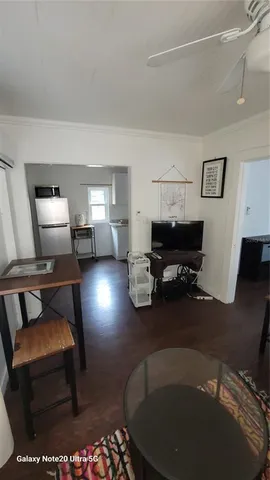 a living room with furniture a piano and a table