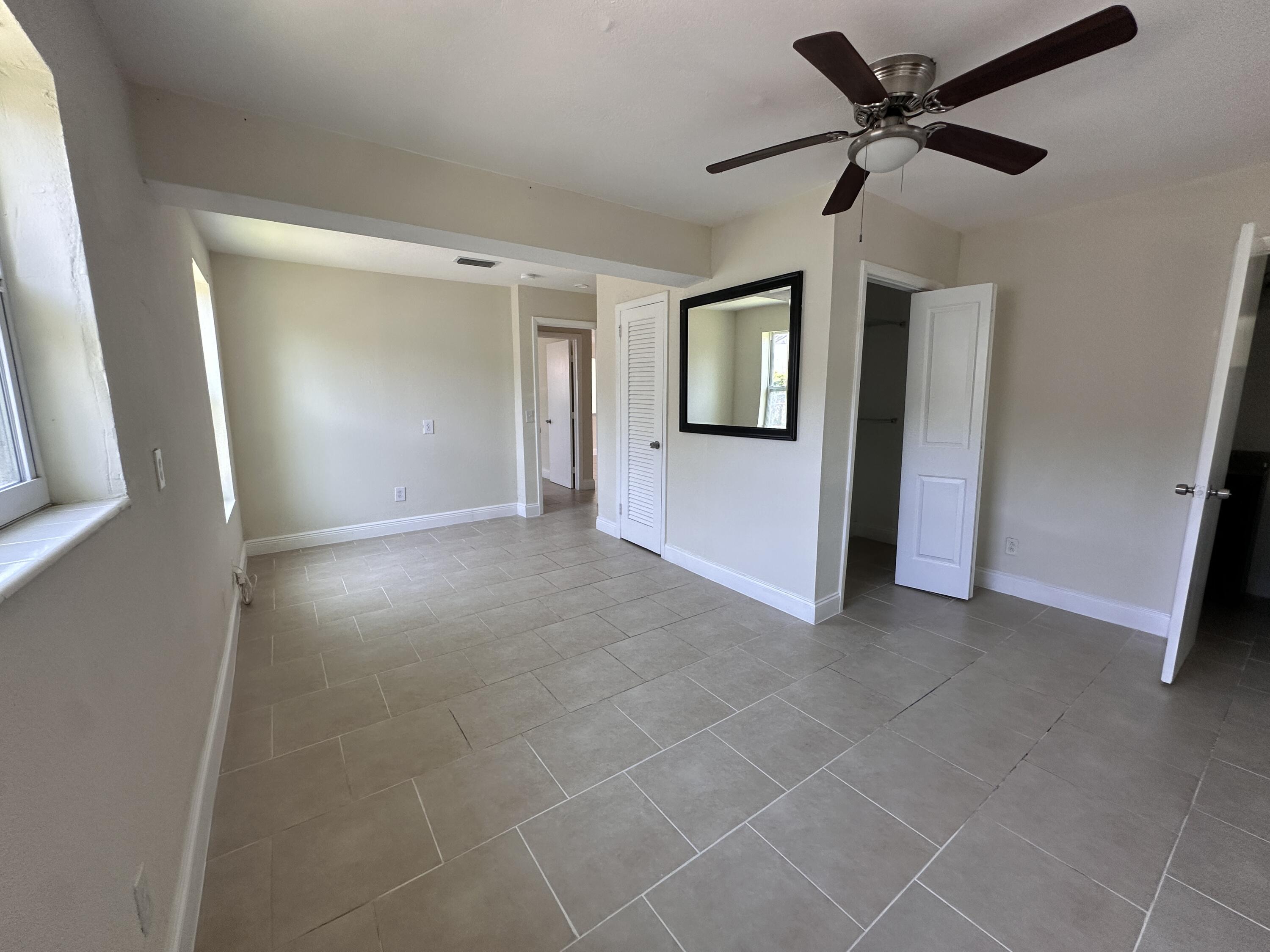 840 West 1st Street Riviera Beach, FL 33404 - Photo 14 of 22 a view of a livingroom with a ceiling fan and window