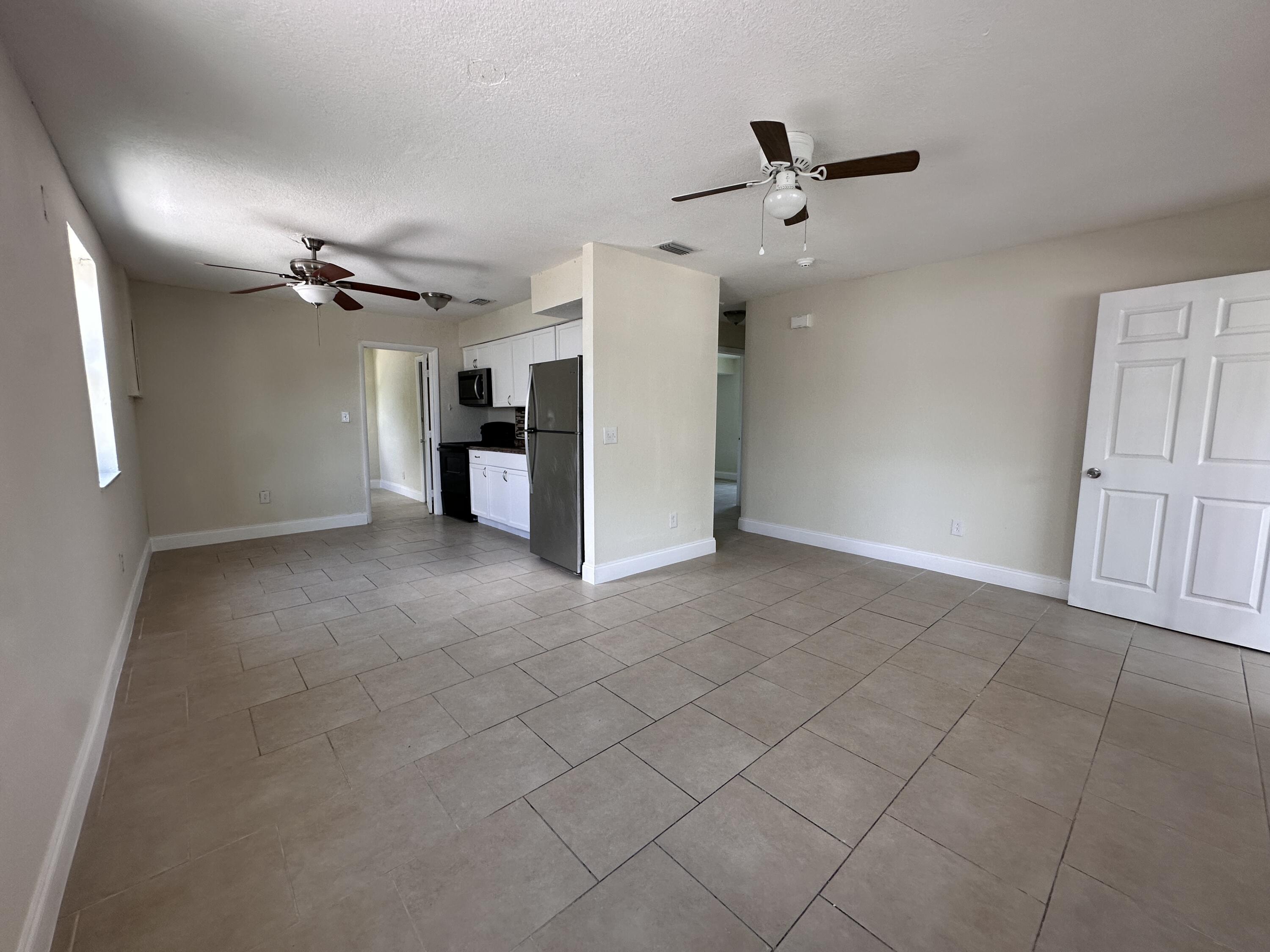 840 West 1st Street Riviera Beach, FL 33404 - Photo 7 of 22 a view of a livingroom with a ceiling fan