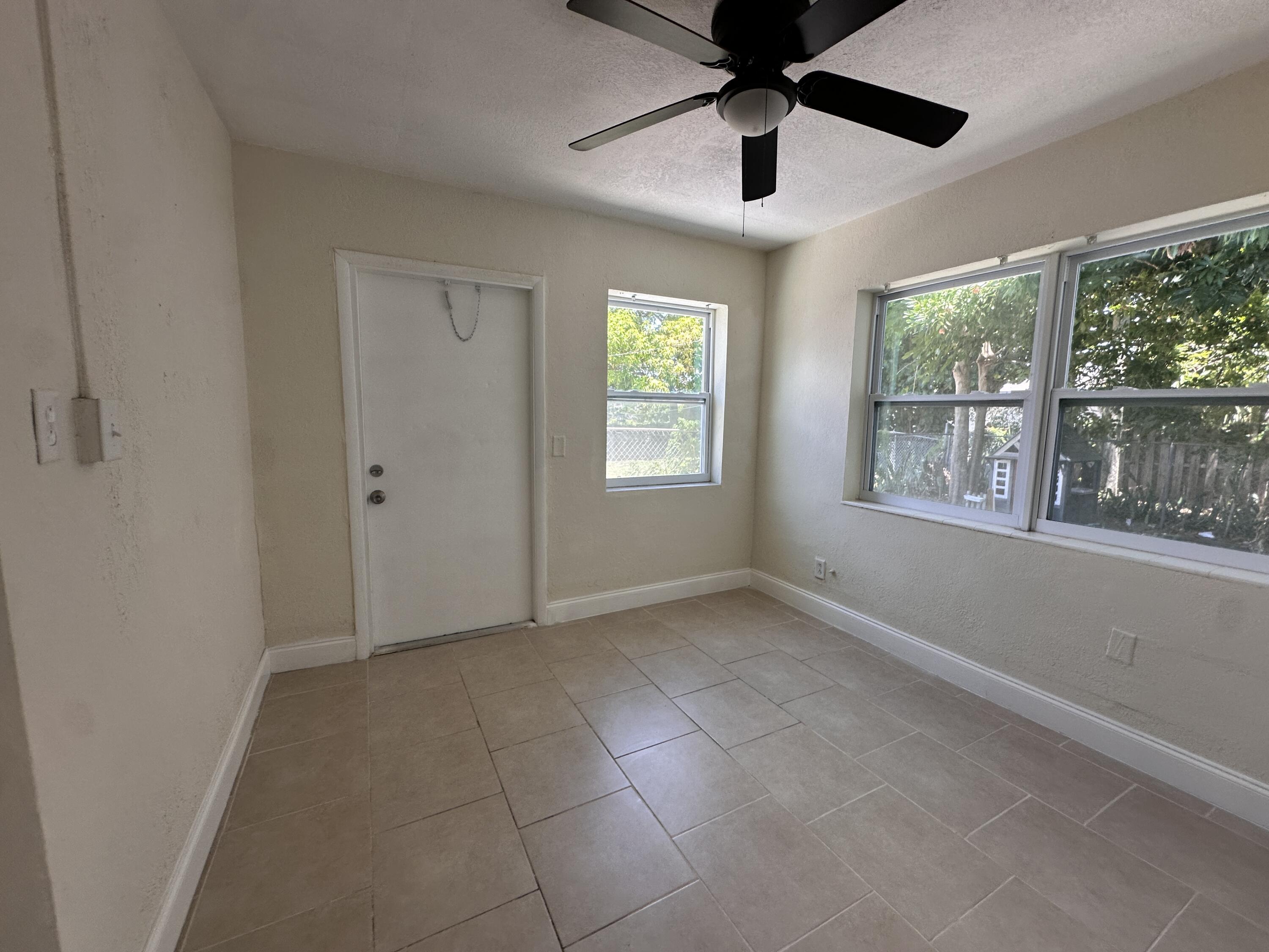 840 West 1st Street Riviera Beach, FL 33404 - Photo 8 of 22 a view of an empty room with a window