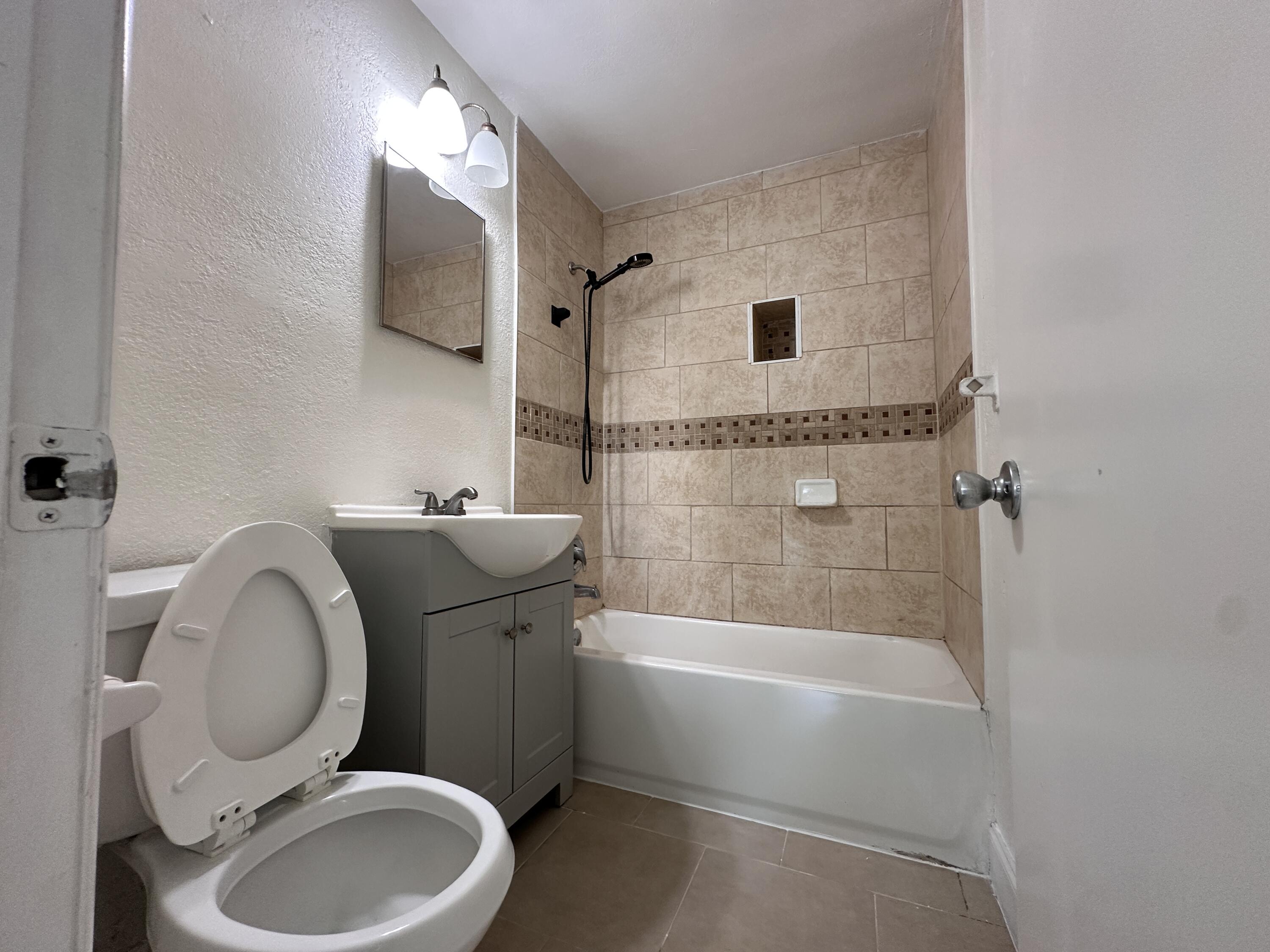 840 West 1st Street Riviera Beach, FL 33404 - Photo 10 of 22 a bathroom with a sink a toilet and shower