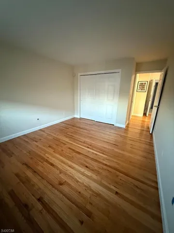 a view of an empty room and wooden floor
