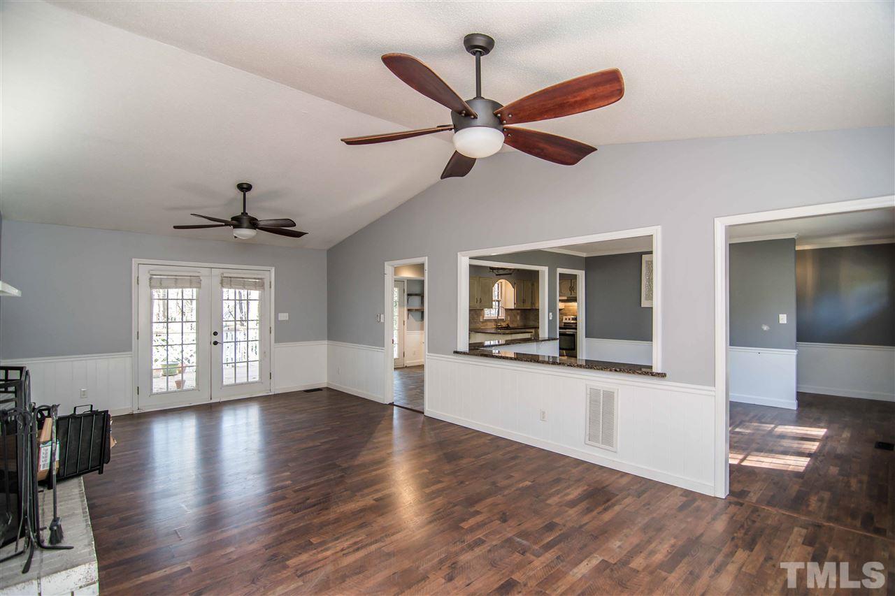 4804 Waybridge Court Raleigh, NC 27606 - Photo 8 of 30 a view of an empty room with wooden floor and a window