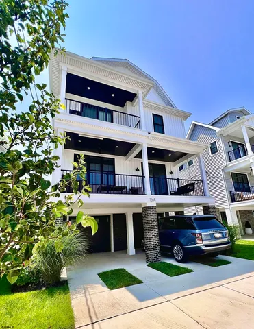 a front view of a building with plants