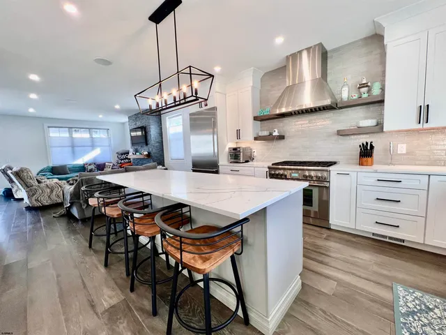 a view of a dining room with furniture wooden floor and chandelier