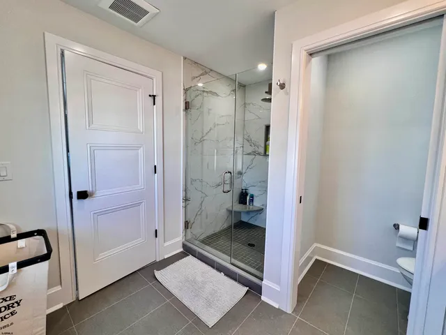 a bedroom with a large bed and a flat screen tv