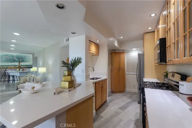 a kitchen with a sink appliances and cabinets