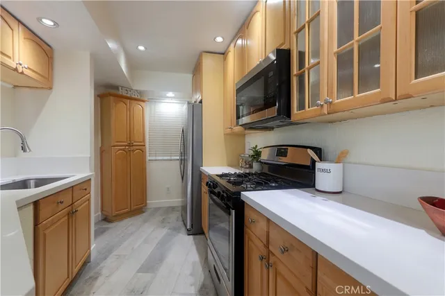 a kitchen with stainless steel appliances granite countertop a refrigerator stove and microwave