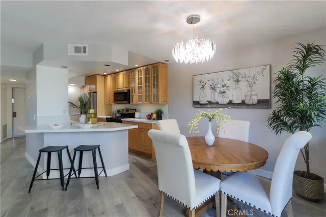 a view of a dining room with furniture and chandelier