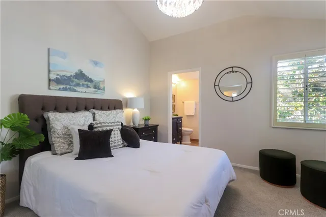 a bedroom with a bed and a mirror