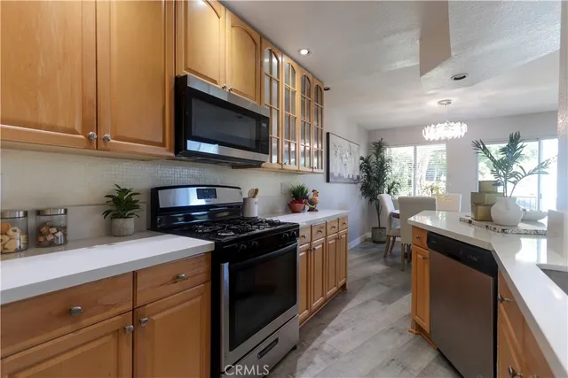 a kitchen with stainless steel appliances granite countertop a sink and a stove