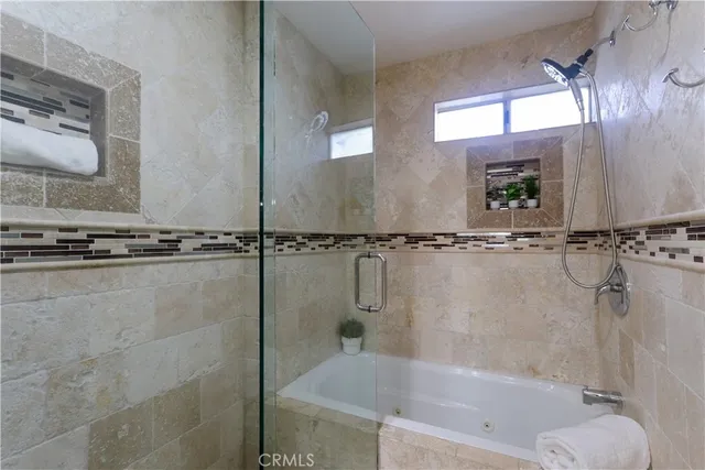 a bathroom with a double vanity sink mirror and shower