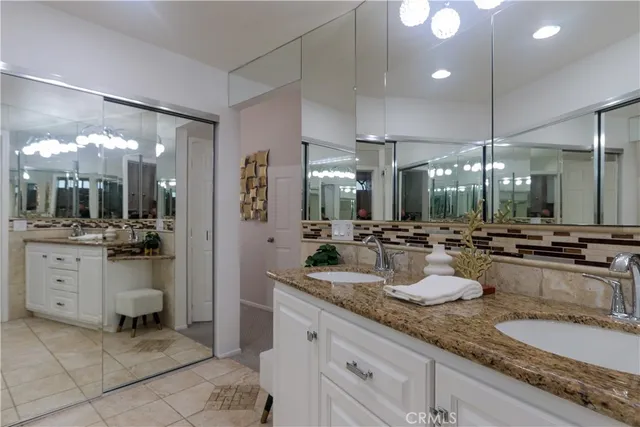 a bathroom with a sink vanity and a mirror