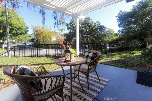 a view of a patio with a table chairs and a backyard