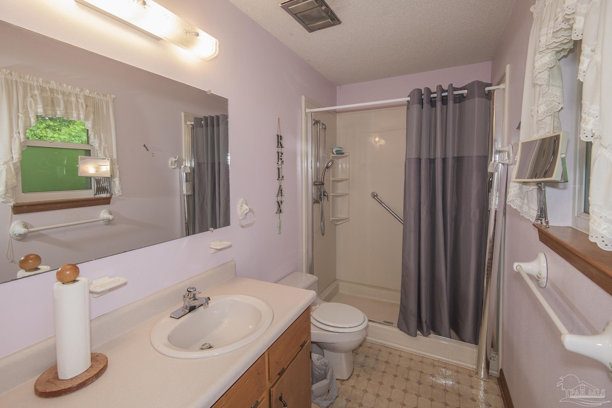 1210 Goldenrod Road Cantonment, FL 32533 - Photo 25 of 50 a bathroom with a sink toilet and shower