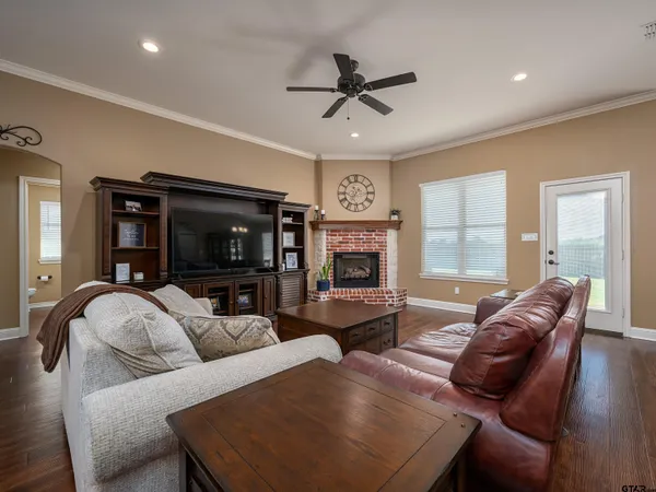 a living room with furniture a flat screen tv and a fireplace