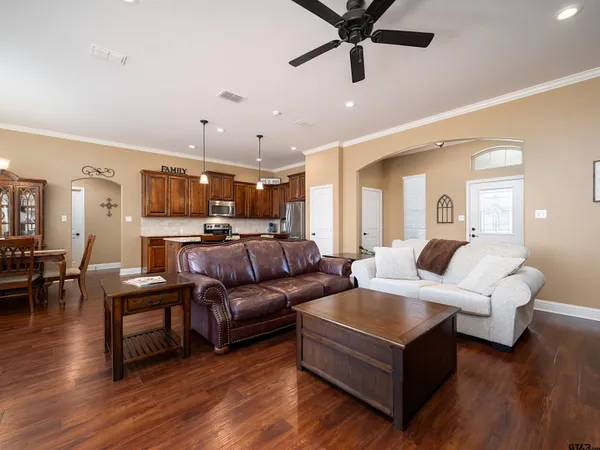 a living room with furniture and a wooden floor