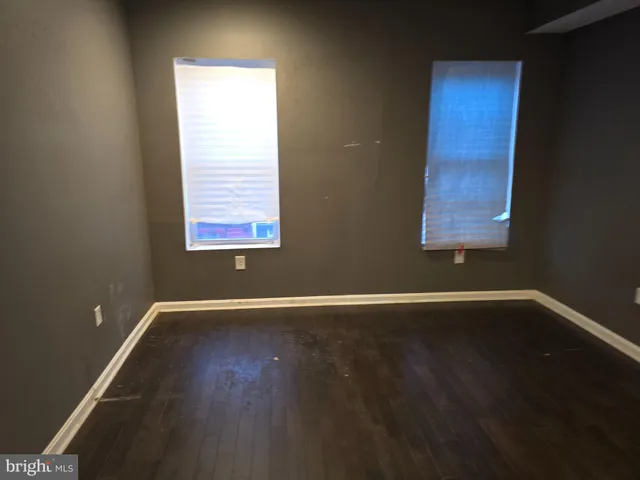 an empty room with wooden floor
