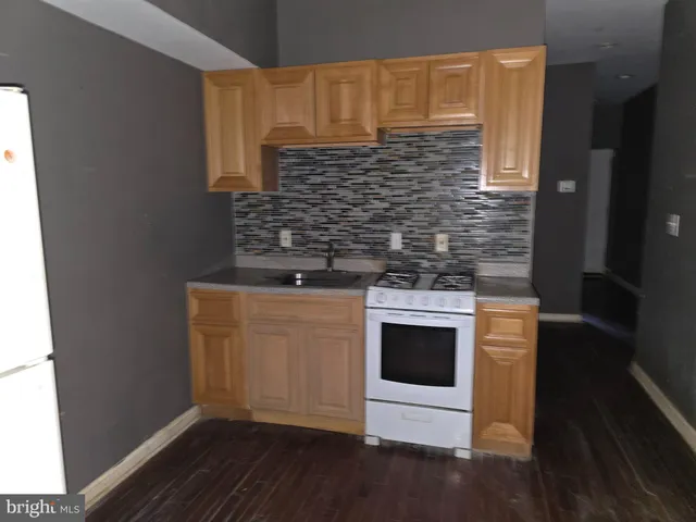 a view of a room with wooden floor and a window