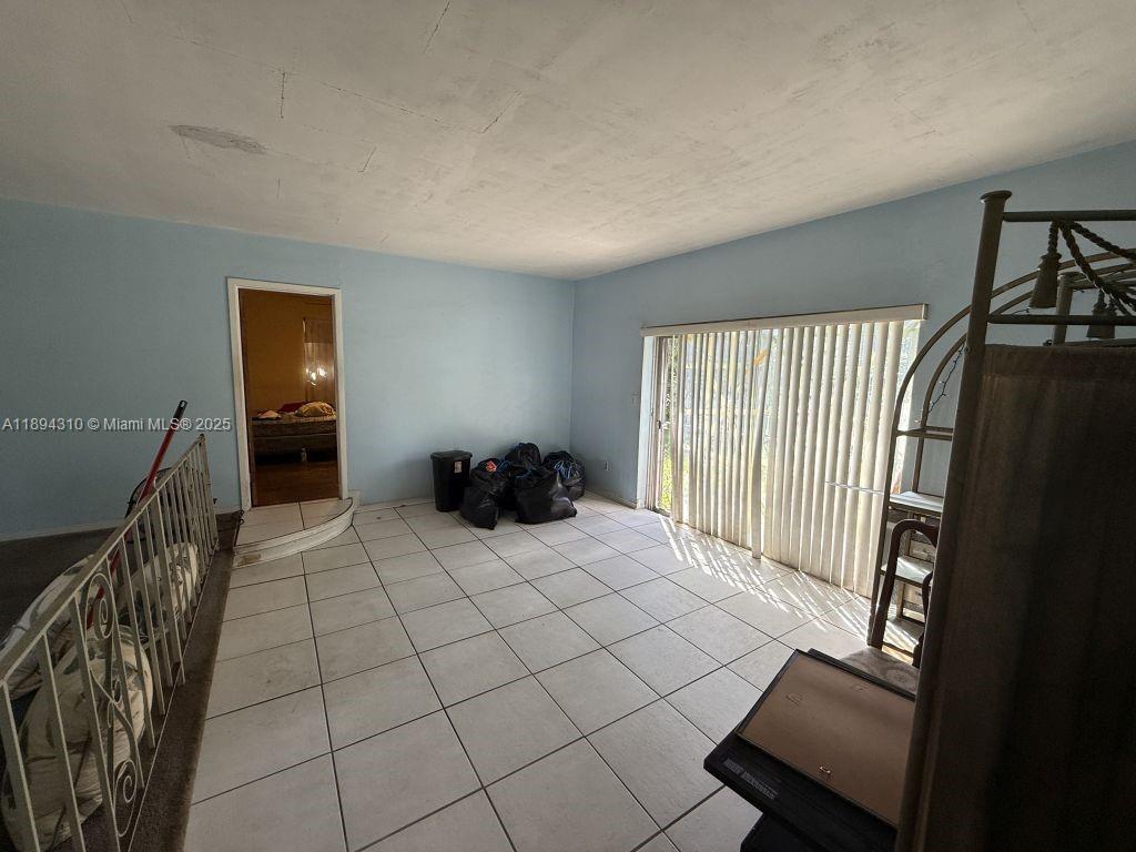 130 Northwest 48th Street Miami, FL 33127 - Photo 11 of 13 a bedroom with a bed and a window