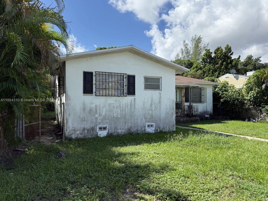 130 Northwest 48th Street Miami, FL 33127 - Photo 2 of 13 a view of a backyard with potted plants and large tree
