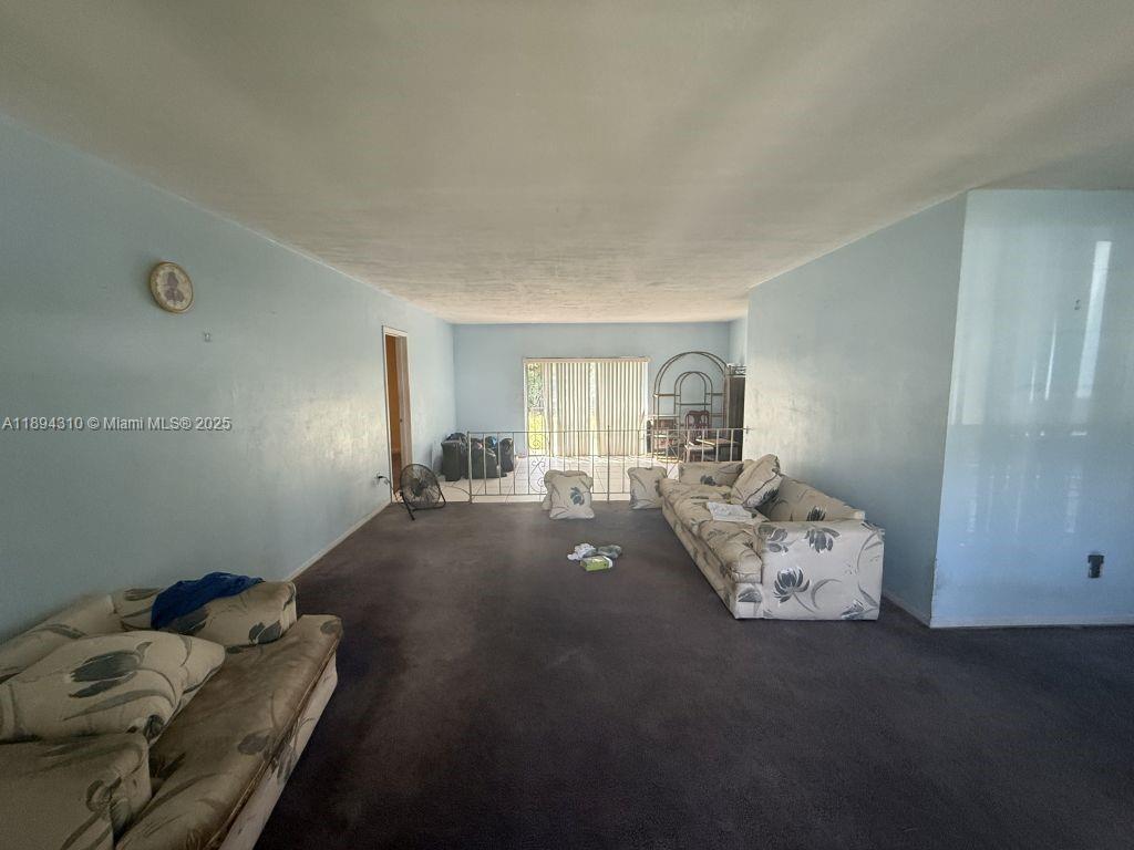 130 Northwest 48th Street Miami, FL 33127 - Photo 3 of 13 a bed sitting in a bedroom next to a window with tv