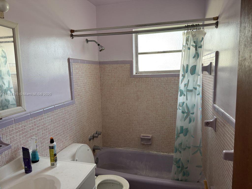 130 Northwest 48th Street Miami, FL 33127 - Photo 4 of 13 a bathroom with a shower and a toilet