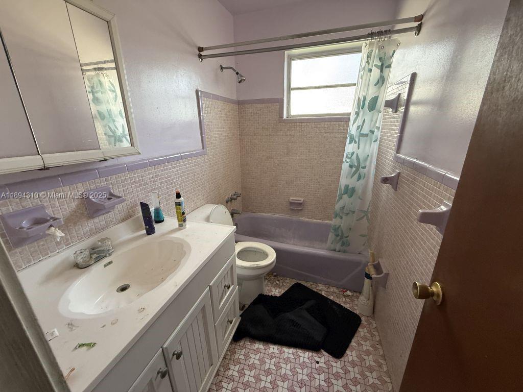 130 Northwest 48th Street Miami, FL 33127 - Photo 5 of 13 a bathroom with a sink toilet and shower