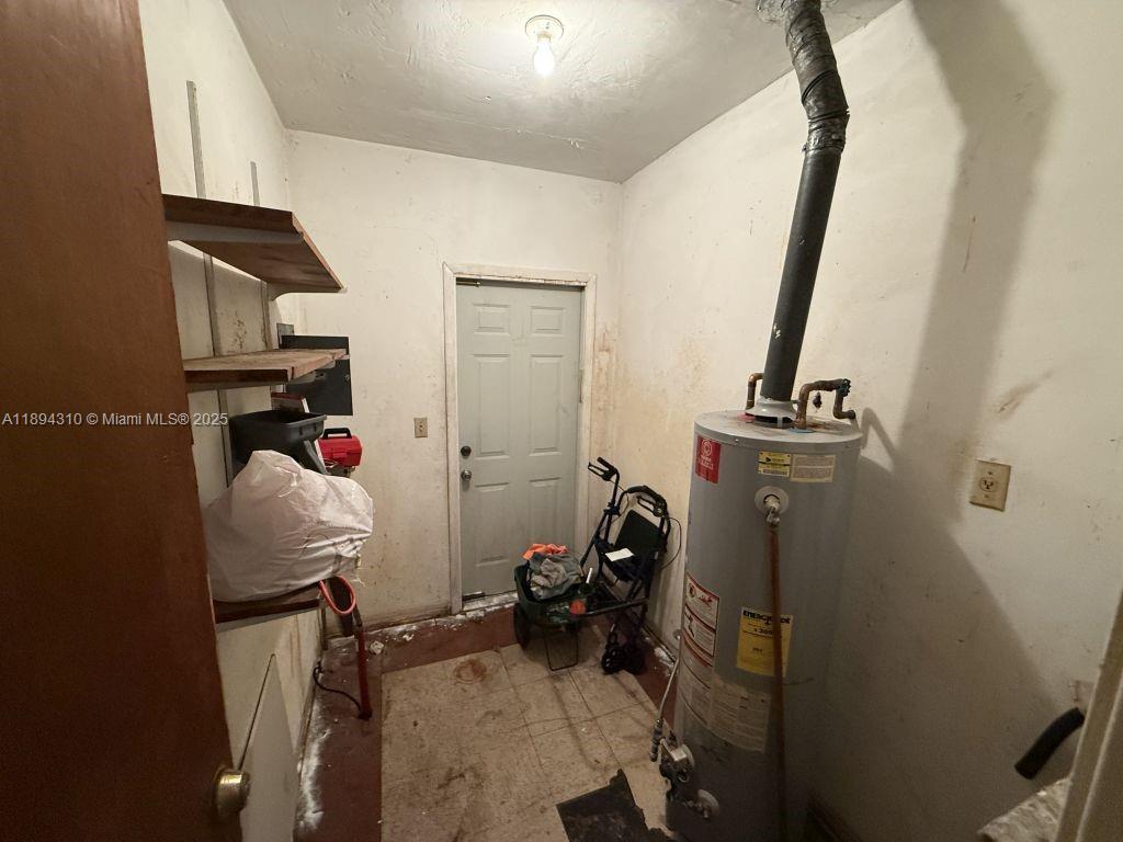 130 Northwest 48th Street Miami, FL 33127 - Photo 9 of 13 a view of walk in closet with clothes and shoes