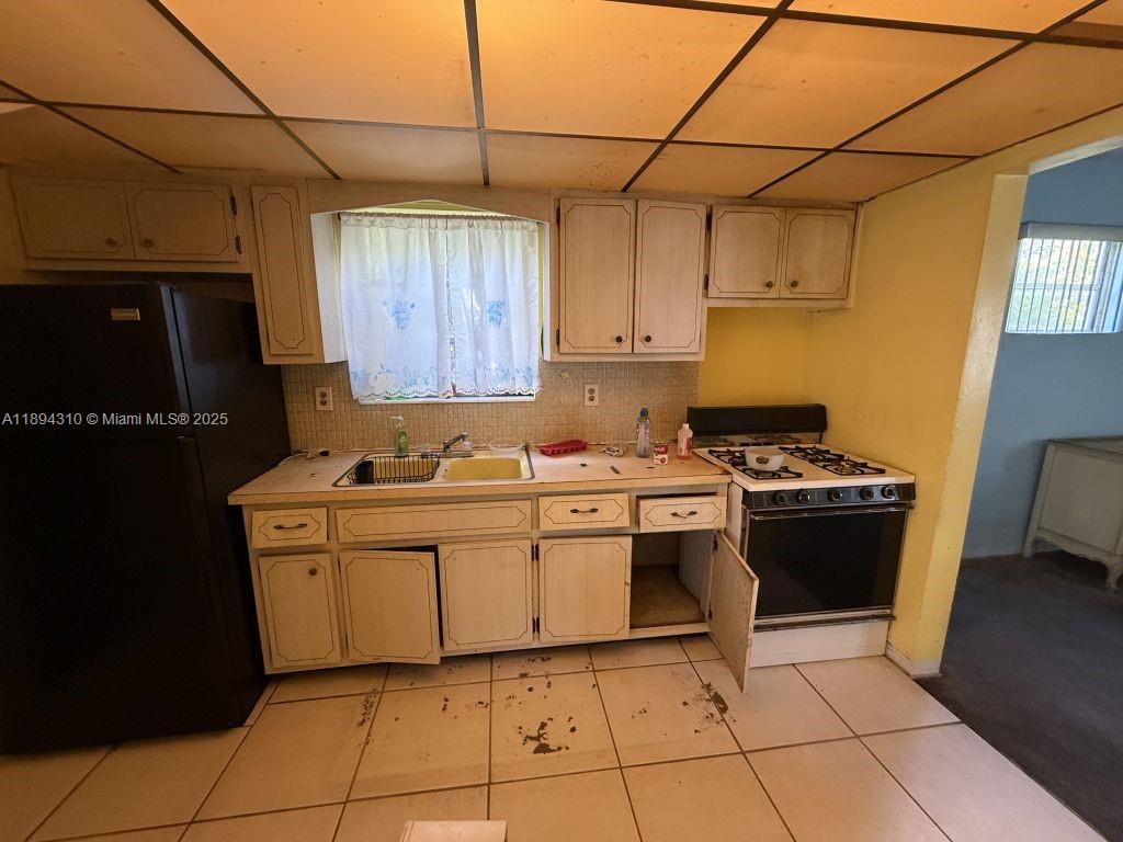 130 Northwest 48th Street Miami, FL 33127 - Photo 10 of 13 a kitchen with a sink cabinets and appliances