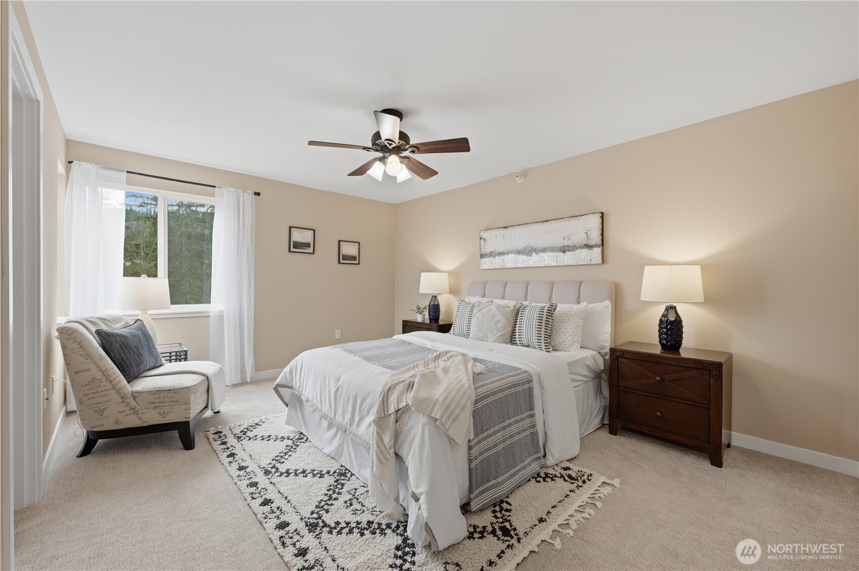 700 Front Street South, Unit E206 Issaquah, WA 98027 - Photo 12 of 32 a spacious bedroom with a bed a couch and a chandelier