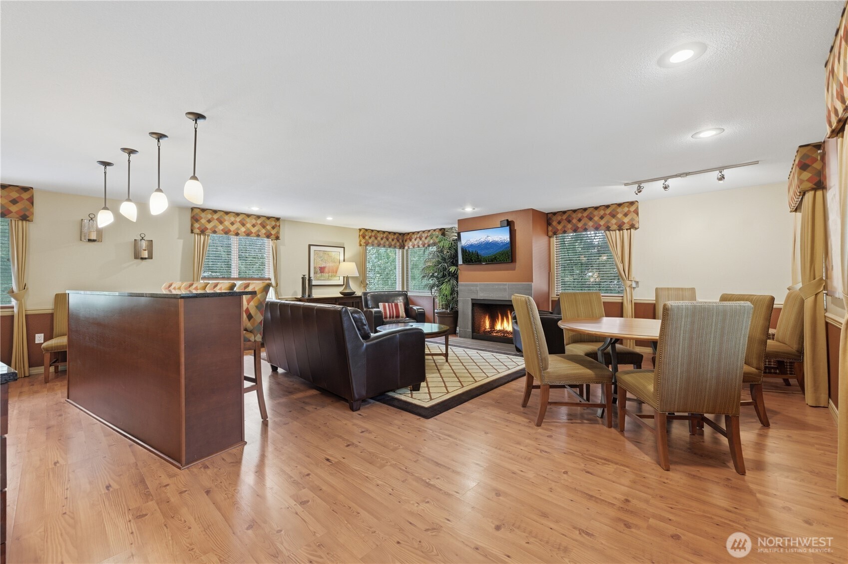 700 Front Street South, Unit E206 Issaquah, WA 98027 - Photo 23 of 32 a living room with furniture a fireplace and a dining table with wooden floor