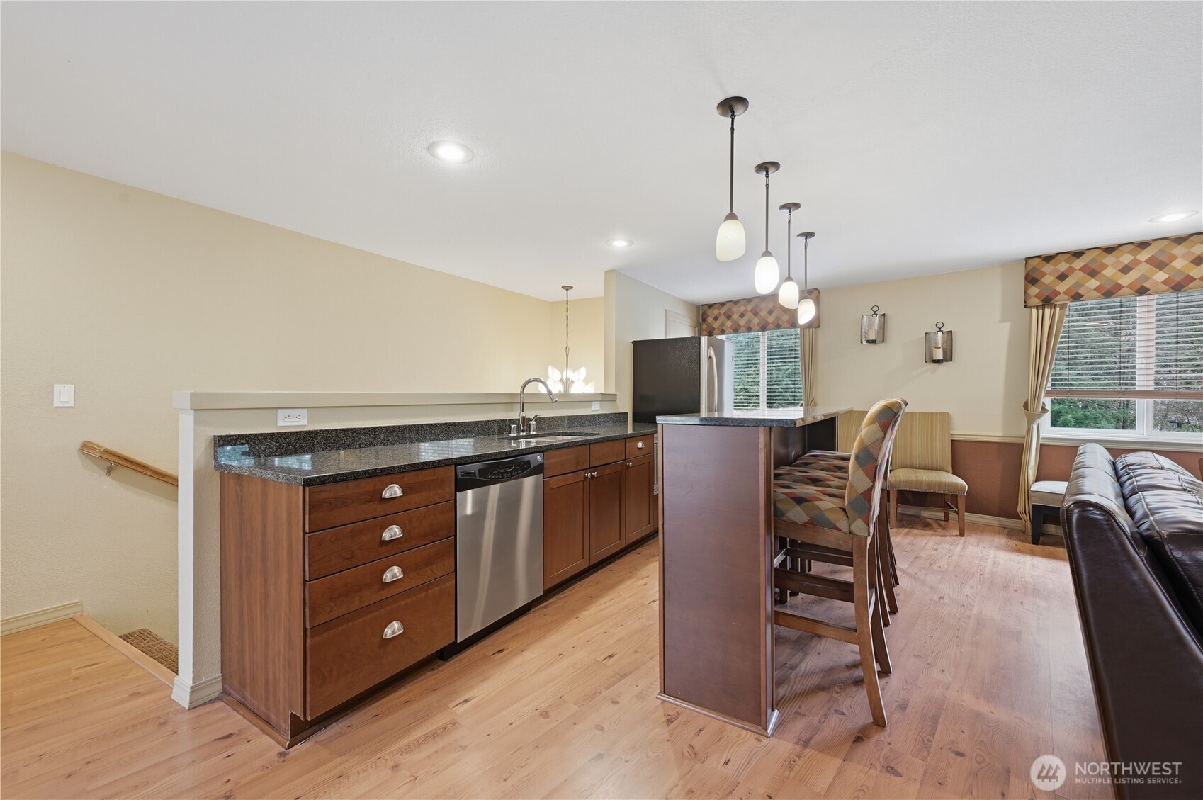 700 Front Street South, Unit E206 Issaquah, WA 98027 - Photo 25 of 32 a kitchen with granite countertop a stove and a wooden floors